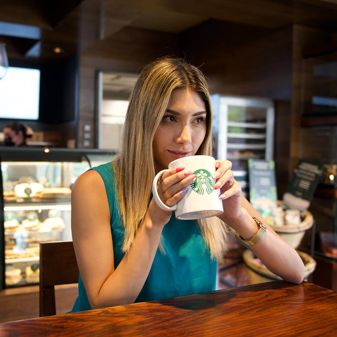 Woman enjoying a Starbucks coffee