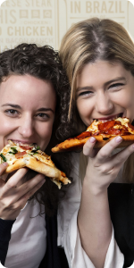 Two happy customers eating pizza